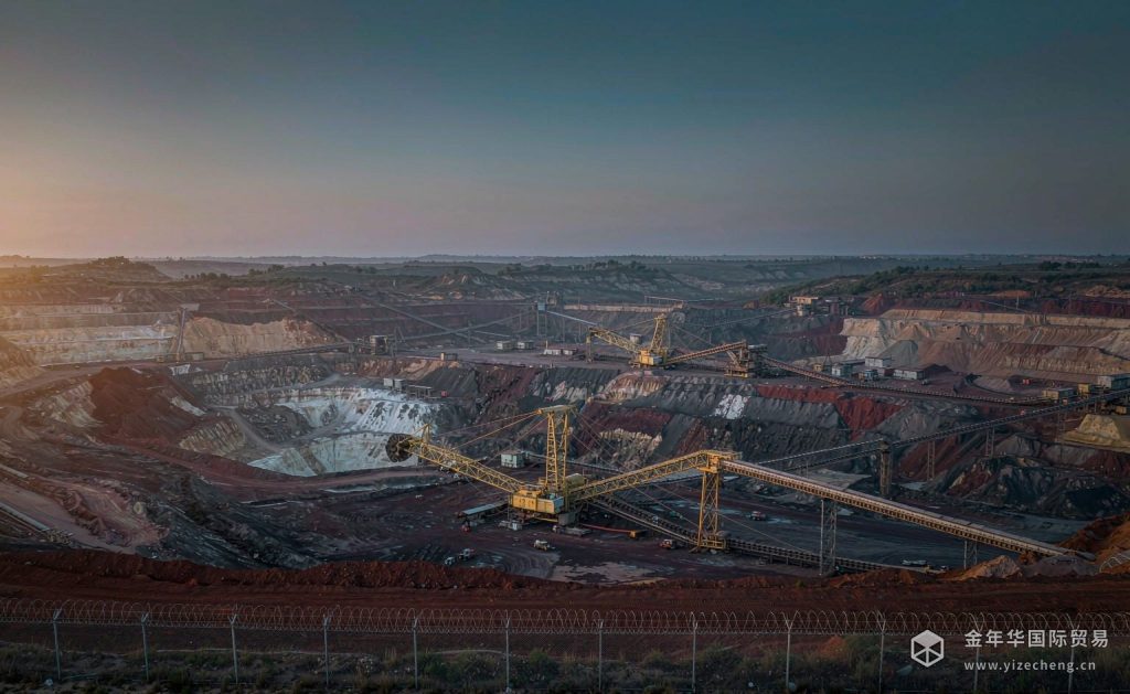 Strategic open-pit phosphate mine at dawn with excavators and conveyors